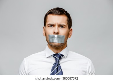 Businessman With Tape Sealed Mouth