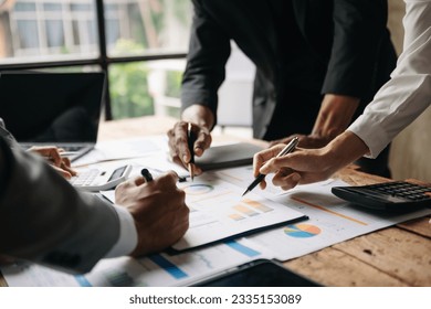 Businessman and team analyzing financial statement Finance task. with smart phone and laptop and  tablet. Wealth management concept at office - Shutterstock ID 2335153089