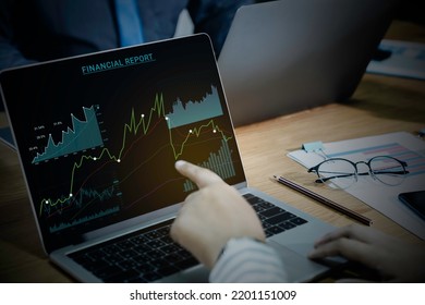 Businessman And Team Work Using Laptop Computer For Auditing The Financial Report Data Of The Company (balance Sheet, Income Statement) On Computer Screen With Business Charts, Fintech.