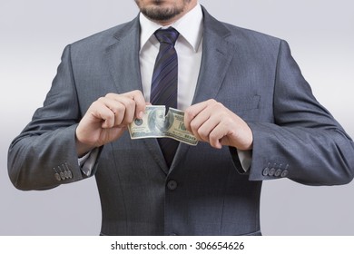 Businessman Tearing Up A Dollar Bill 