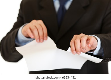 Businessman tearing sheet of white paper isolated on white. Close-up.