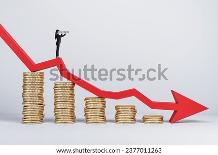 Businessman with telescope standing on abstract falling golden coins chart with red downward arrow in light interior. Financial loss forecast and failure concept