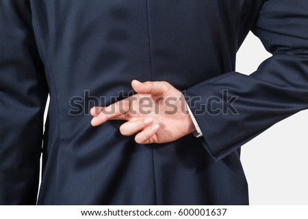 businessman tellimg lies, holding crossed finher his back on white backgrounds, isolated