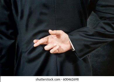 businessman telling lies, hold crossed finger his back - Powered by Shutterstock