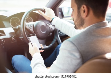 Businessman Texting On His Mobile Phone While Driving. Dangerous Driver.