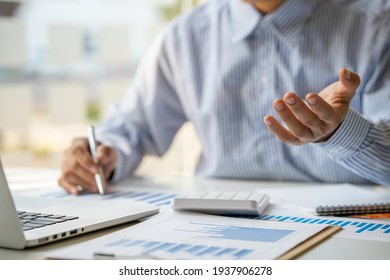 A businessman that operates on the table being checking data, Concept financial transactions online of a businessman, Financier being check about financial transaction past computer with teamwork.
