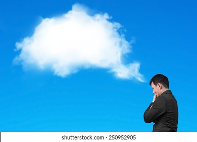 Businessman Thinking About White Cloud Thought Bubble Above His Head Isolated On Blue Background