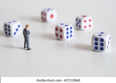 Businessman thinking with dice. Business risk concept. - Shutterstock ID 417113860