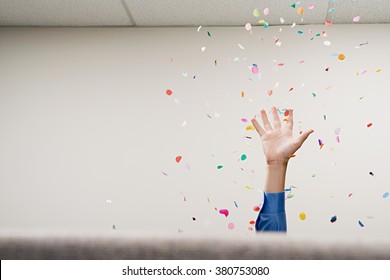 Businessman throwing confetti in the air