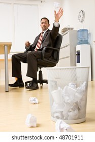 Businessman Throwing Paper In Trash Basket