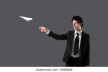 Businessman Throwing A Plane Made Of Paper