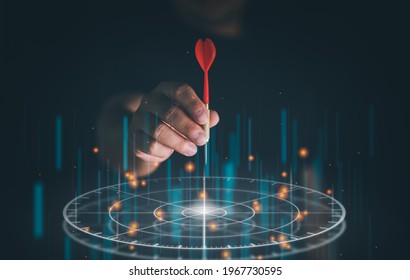 Businessman Throwing Red Arrow Dart To Virtual Target Dart Board. Setup Objectives And Target For Business Investment Concept, Digital Marketing, Business Goal And Technology Concept.