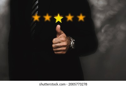 Businessman thumb up pointing at positive five star : Performance appraisal Provide quality grade ratings to ensure successful work satisfaction concept