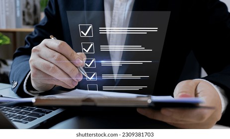 Businessman tick check correct mark to Standardization Quality management with Quality Assurance or QA and Quality Control or QC and improvement, Compliance to regulations and standards. - Shutterstock ID 2309381703