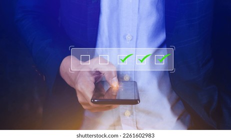 Businessman tick correct sign mark for document approve , project acceptance and quality assurance concept, take an assessment, questionnaire, evaluation, online survey online exam check list - Shutterstock ID 2261602983