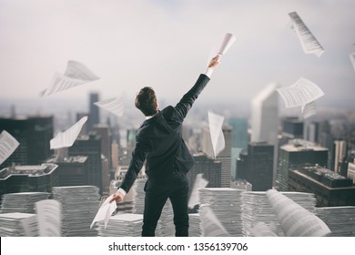Businessman tired of bureaucracy throws up sheets of paper in the air