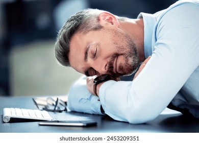 Businessman, tired and sleeping with desk in office with exhausted from overworked in company. Corporate, closeup and burnout from stress in financial analyst job with fatigue, break and low energy - Powered by Shutterstock