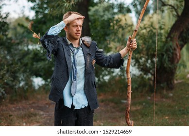 Businessman In Torn Suit Hunting On Desert Island