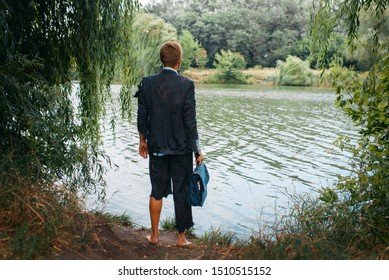 Businessman In Torn Suit On Desert Island