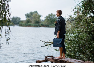 Businessman In Torn Suit On Desert Island