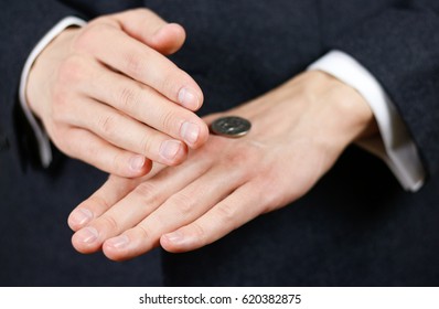 Businessman Tossing A Coin. Heads Or Tails. Close Up.