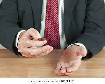 Businessman Tossing UK Coin At Desk