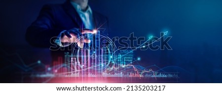 Businessman touch growth graph and progress of business and analyzing financial and investment data ,business planning and strategy on city background.