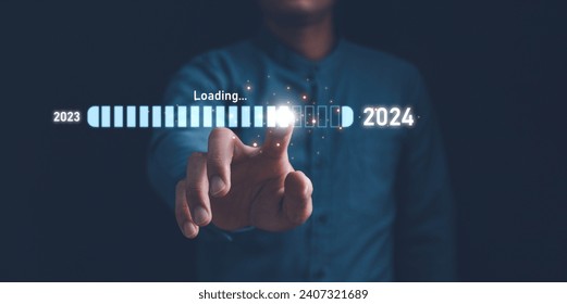 Businessman touch on loading progress from 2023 to 2024,Planning and challenge strategy in new year 2024 Concept. New business startup in 2024. New year 2024 is loading, calendar date, end of the year