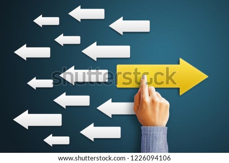 Businessman is touching arrow pointing opposite with arrows white  as a symbol of growth and success or rising successful development and business development in the future