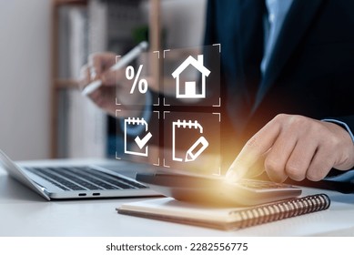 Businessman touching calculator for home loan concept, performance assessment and property value, contracts and percentage icons, loan amount, interest rate, loan term, mortgage, electronic signature.