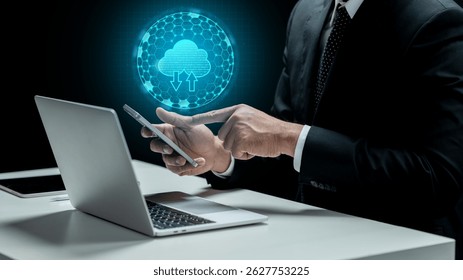 Businessman touching cellphone with cloud computing icon. Laptop and tablet on the desk. Technology innovation on the virtual screen. Concept of a Data Center
