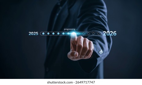 Businessman touching digital progress bar from 2025 to 2026 symbolizing future planning, strategic transition, innovation, and growth with focus on leadership, success, and business development.