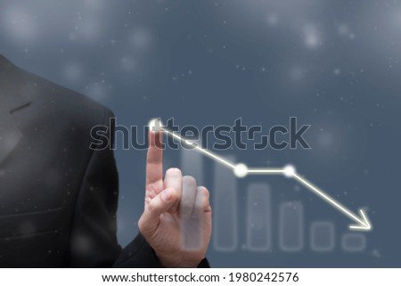 Businessman touching dropping diagram graph. Economy going down. Falling prices, bankruptcy, crisis concept. Blurred defocused view
