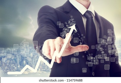Businessman Touching a Graph Indicating Growth