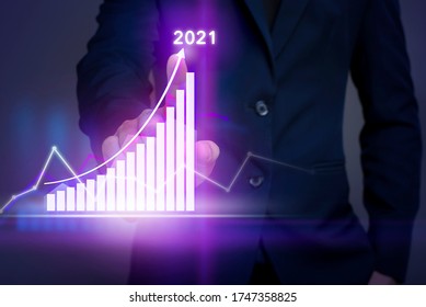 Businessman Is Touching Growing Graph On Virtual Screen With Business Strategy Plan For 2021