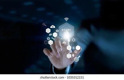 Businessman touching icon start up and icon network connection on modern virtual interface