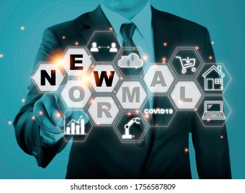 Businessman Touching New Normal Wording With Icon Such As Online Shopping Social Distancing Work From Home And COVID19.The World Is Changing To Balance It Into New Normal Include Business , Economy , 