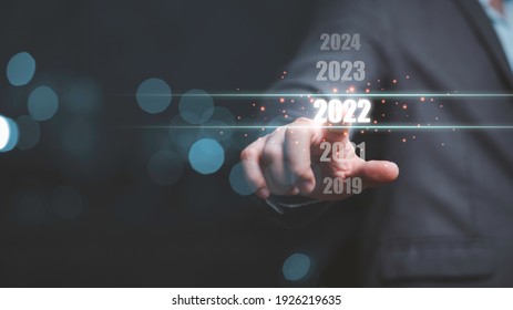 Businessman touching on number 2022 for preparation and change to merry Christmas and happy new year. - Powered by Shutterstock