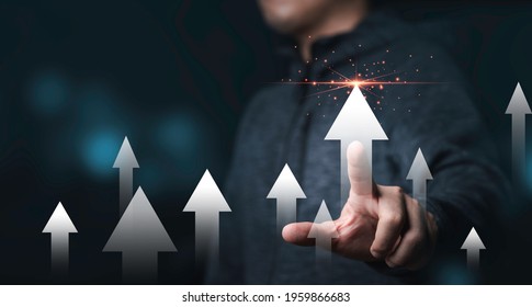 Businessman touching rise up white arrow for business and profit growth concept. - Shutterstock ID 1959866683