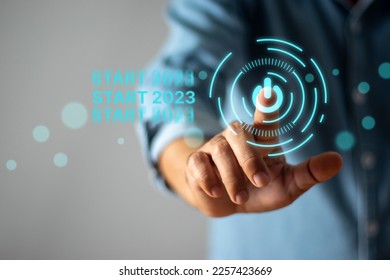 Businessman touching start button in 2023 - Shutterstock ID 2257423669