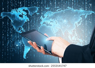 Businessman touching tablet screen, glowing digital world map overlay with binary data on dark background, concept of global technology network