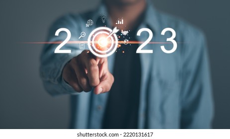 Businessman touching target icon on virtual screen. Startup business 2023. merry Christmas and happy new year concept.  - Shutterstock ID 2220131617