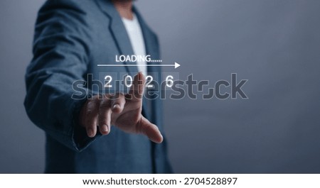 Businessman touching virtual interface with loading 2026 concept. Future planning, business forecast, innovation and digital transformation for next year strategy and opportunities.
