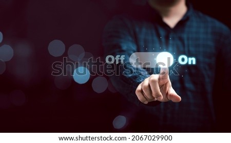 Businessman touching to virtual toggle switch button for change from off to on.
