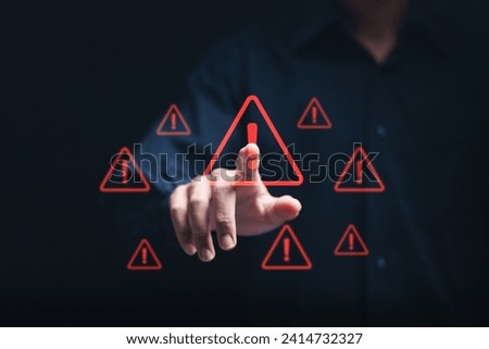 Businessman touching virtual warning sign for caution in investing economic situation warning, Business investment risks.