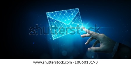 Businessman touching wireframe e-mail. Email marketing, newsletter, contact us concept