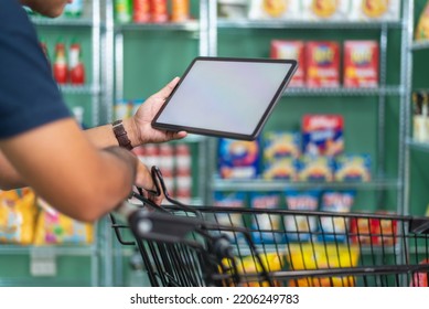 Businessman With Touchscreen Tablet Checking Inventory In Stock Room. Store House Inspection