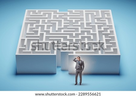 Businessman trying to find a way out of maze