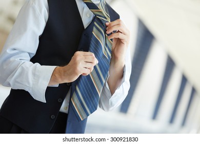 Businessman tying his tie - Shutterstock ID 300921830