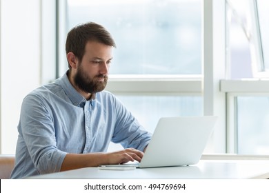 Businessman typing on laptop - Shutterstock ID 494769694